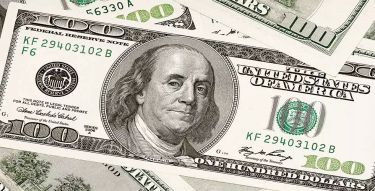 An American $100 bill featuring the face of Benjamin Franklin.