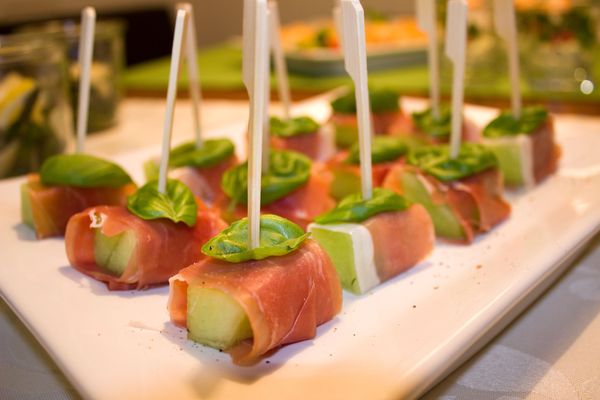 A plate of hors d'oeuvres with toothpicks in them.