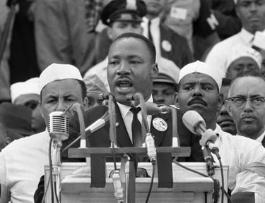Martin Luther King Jr. speaking at a podium during his "I Have a Dream" speech.