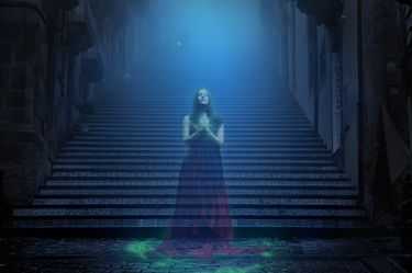 A ghostly woman standing at the base of a long staircase.