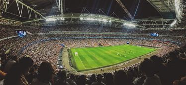 A soccer stadium packed with fans during a night game.